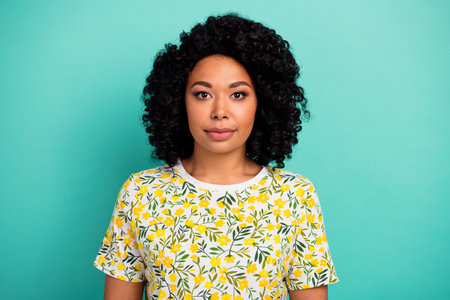 Photo of charming positive woman wear flower t-shirt smiling empty space isolated turquoise color...