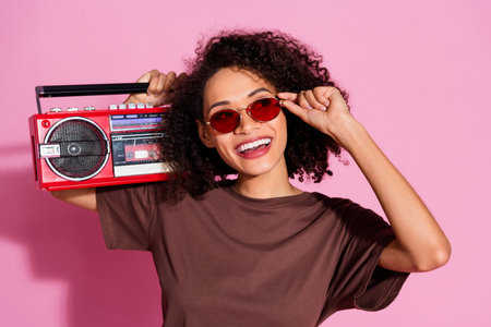 Photo of charming cheerful funny girl wear brown trendy clothes look empty space isolated on pink color backgroundの写真素材