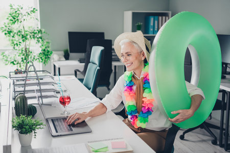 Photo of lovely senior lady cocktail summer vacation swimming ring wear formalwear coworking successful businesswoman creative light officeの写真素材