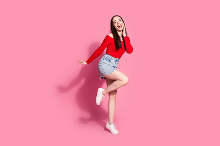 Full size photo of gorgeous young woman empty space isolated on pink color backgroundの写真素材