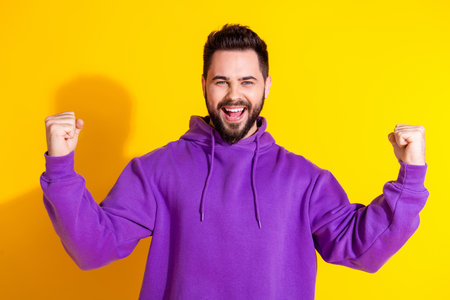 Photo of cheerful attractive lucky man wear purple trendy clothes rejoice win power strength...