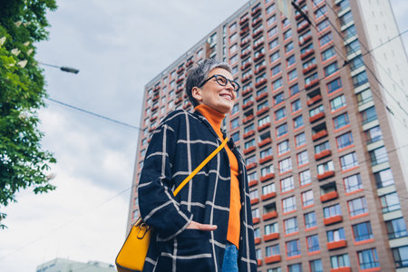 Low angle view portrait of nice aged woman free time walk downtown street outdoorsの写真素材