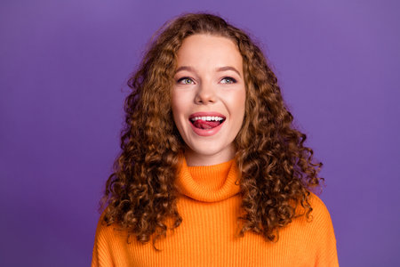 Portrait photo of wavy red hair young woman in turtleneck good mood lick teeth protrude tongue...