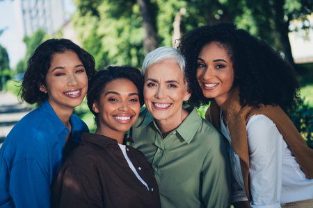 Photo portrait of happy multi generational women cheerful smile together multiracial friends outdoor city parkの写真素材