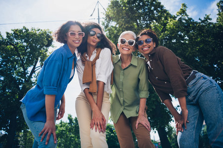 Photo of company friends women smile enjoy free time chill walk city park outdoorsの写真素材