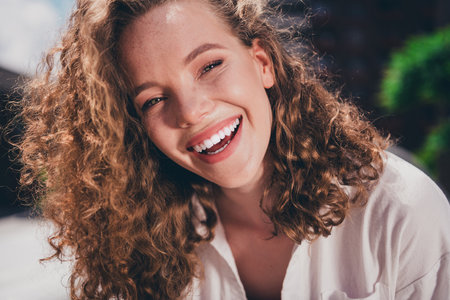 Photo of excited dreamy lady cheerful smile good mood wear white shirt walking outside modern urban city streetの写真素材