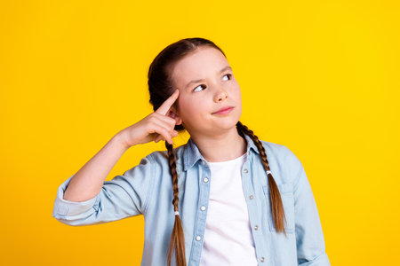 Photo of charming cute dreamy girl wear trendy clothes look empty space isolated on yellow color...