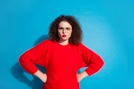 Photo portrait of lovely young lady annoyed pose scolding dressed stylish red garment isolated on blue color backgroundの写真素材