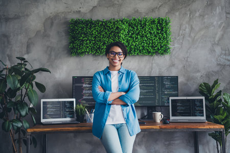 Photo of attractive woman confident posing boss crossed hands wear blue shirt modern office programmer loft room interior indoors workspaceの写真素材