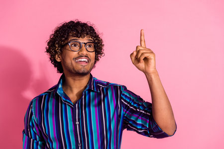 Photo of nice young man look direct finger empty space wear shirt isolated on pink color backgroundの写真素材