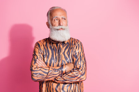 Photo of cool confident old man cross arms feel serious look empty space wear shiny shirt isolated...