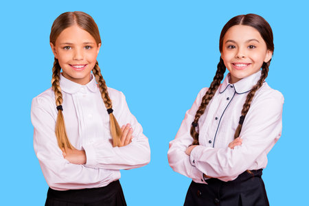 Portrait of nice attractive lovely charming confident cheerful cheery positive pre-teen girls folded arms isolated over bright vivid shine orange backgroundの写真素材