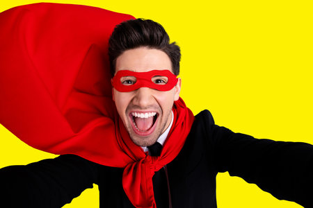 Close up photo adventurous facial expression he him his man flying use superpower make take selfies wear red long cloak raised wind safety protection human comics character isolated grey backgroundの写真素材
