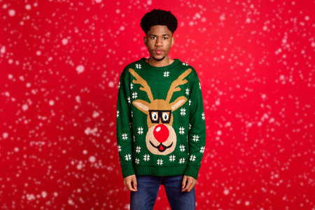 Portrait of attractive confident calm guy wearing cozy casual festal jumper isolated over bright red...