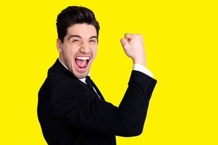 Close up portrait emotional millennial chairmen executive feel thrilled scream shout yeah raise fists expression impressed celebration contract modern classic outfit isolated grey backgroundの写真素材
