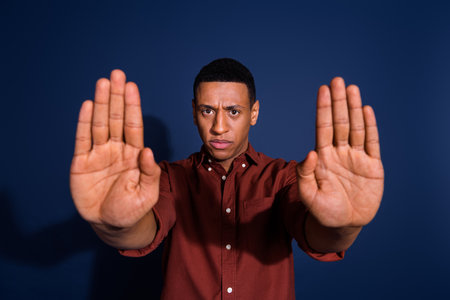 Photo portrait of attractive young man stop gesture no dressed stylish brown clothes isolated on...