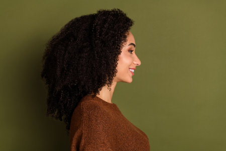 Profile photo of nice young woman empty space wear pullover isolated on khaki color backgroundの写真素材
