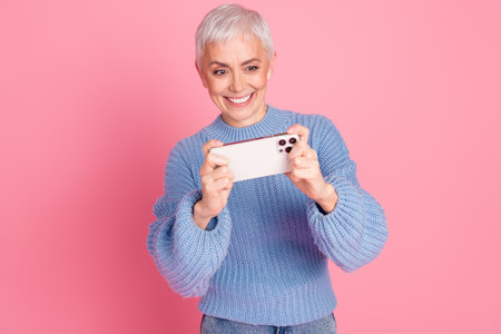 Photo portrait of lovely pensioner lady play mobile game dressed stylish blue knitwear garment...