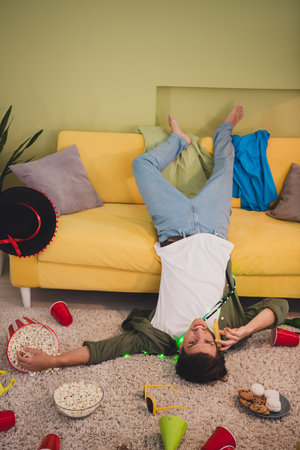 Photo of attractive young guy after party celebration weekend relax rest indoors living room home...