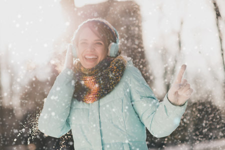 Photo of charming young attractive woman dance good mood smile music lover winter season outside outdoorsの写真素材