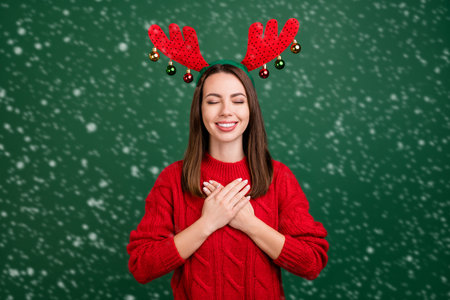 Photo of young girl happy positive smile hands on chest dream grateful headband isolated over green color backgroundの写真素材