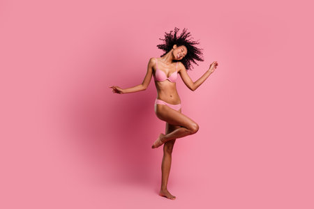 Full length photo of dreamy seductive woman underwear having fun enjoying self acceptance empty space isolated pink color backgroundの写真素材