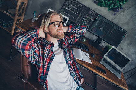 Photo portrait of programmer young handsome man wearing checkered shirt take nap chilling laying on...