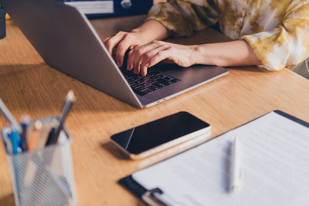 Cropped photo of pretty senior female hands typing netbook keyboard wear formalwear coworking successful nice light officeの写真素材