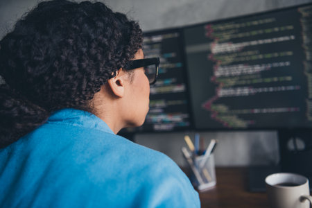 Photo of young lady back view coding developer look monitors dressed blue shirt comfortable...