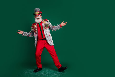 Full body portrait of christmas party presenter red pants decorated blazed empty space isolated on...
