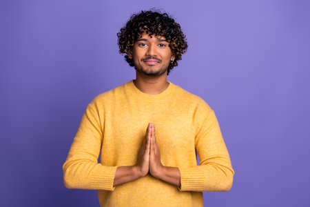 Photo of dreamy nice man wear trendy yellow clothes arms together pray gesture isolated on violet...