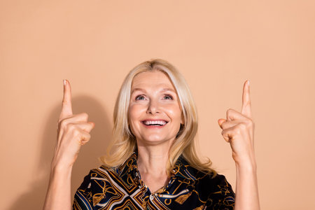 Photo portrait of blonde hair happy mature marketer lady indicating fingers up nice proposition...