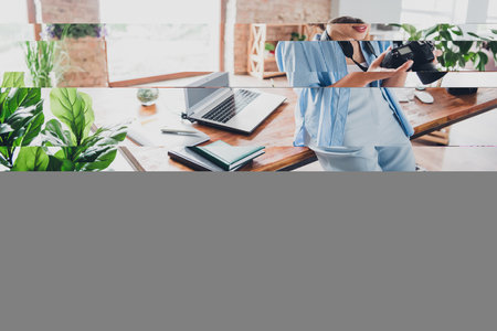 Portrait of young lady photographer hold camera spacious loft interior office studio indoorsの写真素材