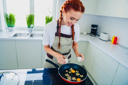 Photo of adorable charming girl cooking breakfast tasty healthy meal modern kitchen home house day light indoorsの写真素材