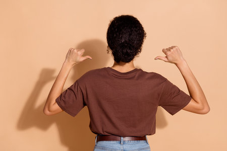 Rear side photo of charming adorable woman wear brown trendy clothes indicating herself isolated on...
