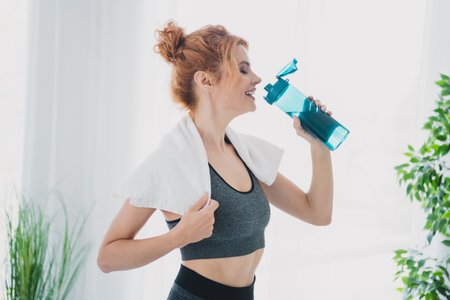 Photo of athletic pretty woman wearing activewear doing physical exercises from home living room...