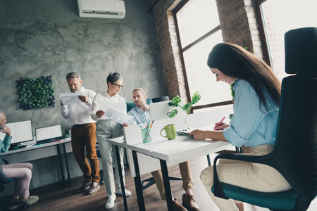 Full length photo of teamwork startup partners people coworking comfortable nice creative startup...