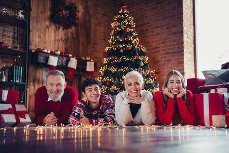 Photo of happy family grandmother grandfather grandson granddaughter lying floor celebrate christmas...