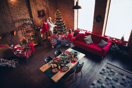 High angle view photo of peaceful family decorate tree open presents celebrate festive christmas time apartment indoorsの写真素材