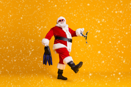 Full length profile side photo of white greay hair bearded santa claus go hold flins flippers breathing mask x-mas christmas hobby rest wear red hat isolated bright shine color backgroundの写真素材