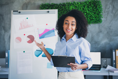 Photo of cheerful positive lady recruiter dressed shirt showing graphics indoors workplace...