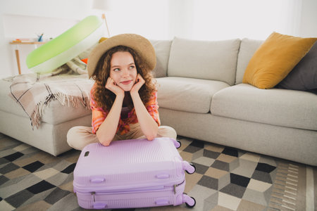 Photo of dreamy lady sit packing trip luggage thinking in house indoorsの写真素材