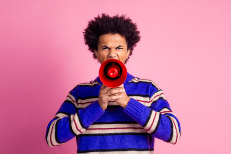 Photo of strict angry bossy man guy with wavy hairstyle dressed knitwear sweater scream in megaphone isolated on pink color backgroundの写真素材