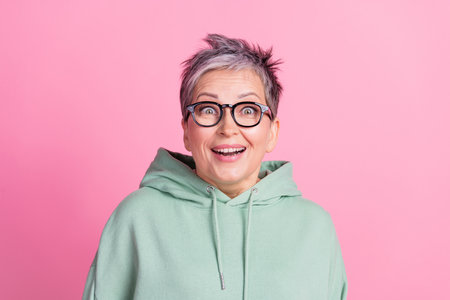 Photo of charming attractive lady wear khaki hoodie open mouth empty space isolated pink color...