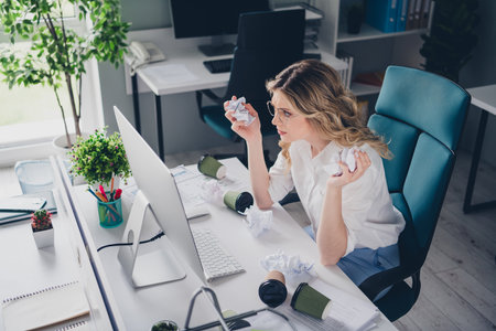 Photo of pretty young girl annoyed manager tired crumpled paper wear formalwear coworking successful nice light officeの写真素材