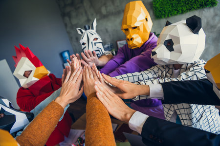 Photo of panda rooster gorilla zebra raccoon mask people pile stack handshake loft interior office indoorsの写真素材