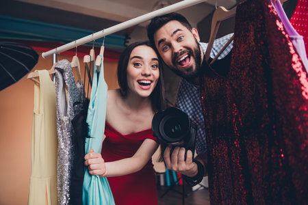 Backstage in photo studio stylist choose clothes create outfit for attractive model girl fashion indusrty photoshootの写真素材