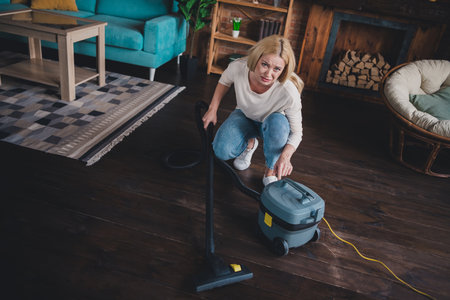 Photo of pretty upset lady wear casual shirt dislike doing spring clean up indoors room home houseの写真素材