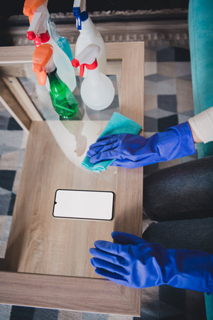 Cropped photo of lady doing spring clean up modern device blank space indoors room home houseの写真素材