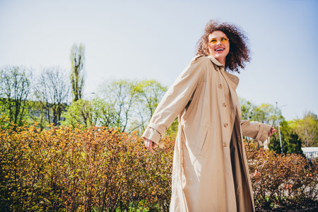 Photo of lovely cute pretty girl wearing trendy beige trench walk park weekend trip spring weather outdoorsの写真素材